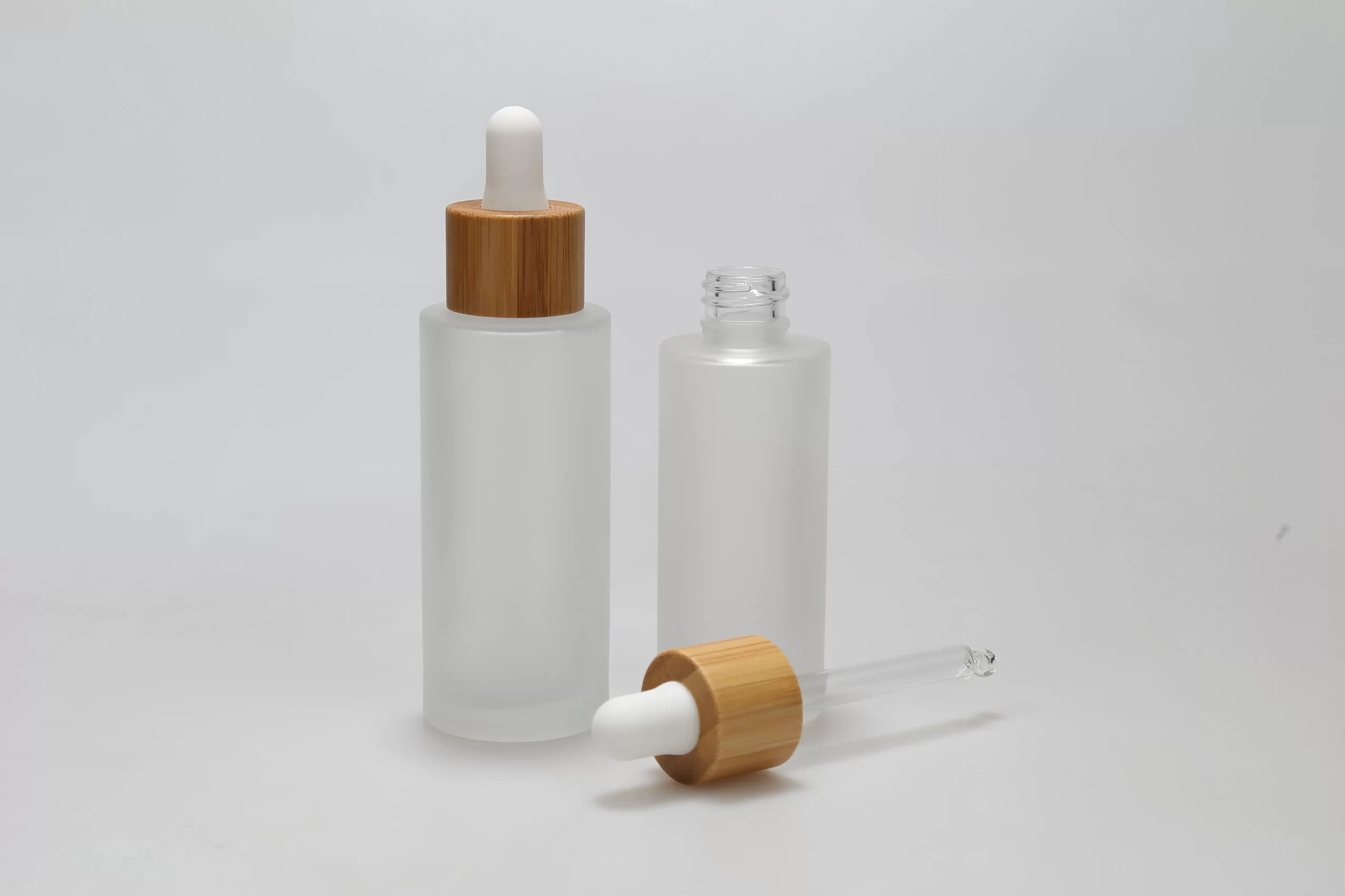 Glass dropper bottle with bamboo dropper cap